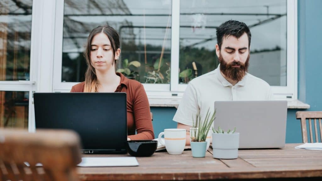 Man and woman working on their own