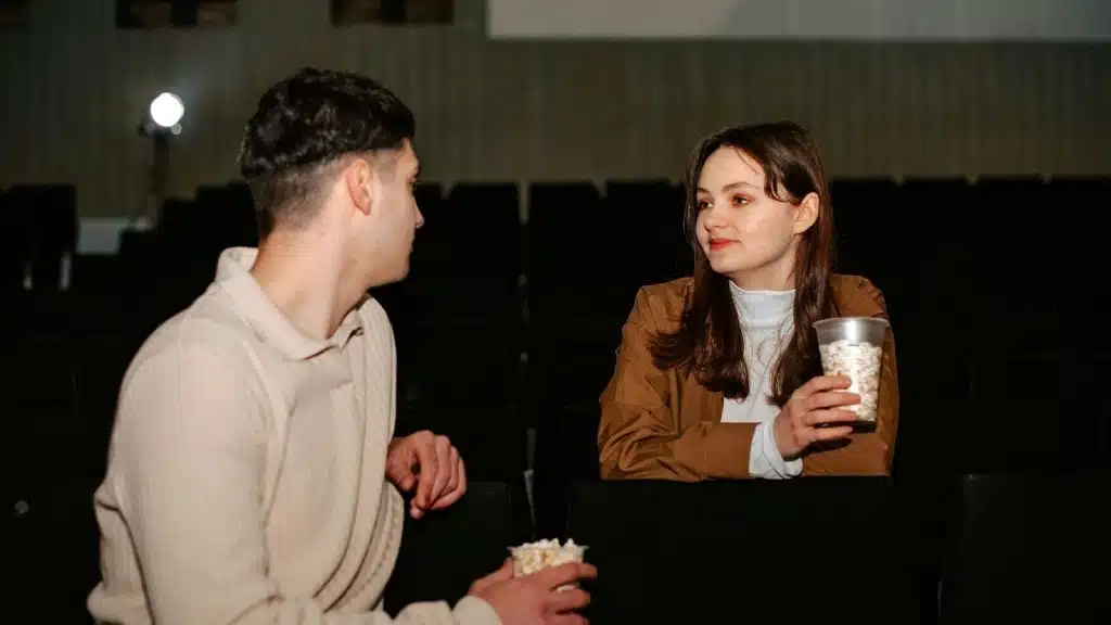 Woman smiling awkwardly to a man