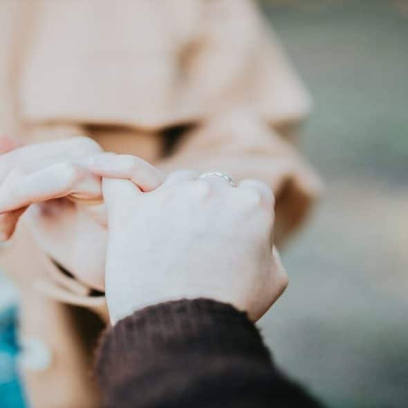 Two people doing the pinky promise