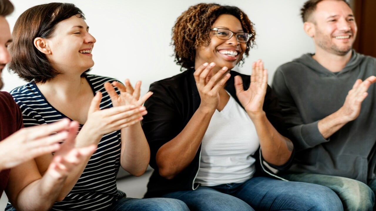 A group of people clapping