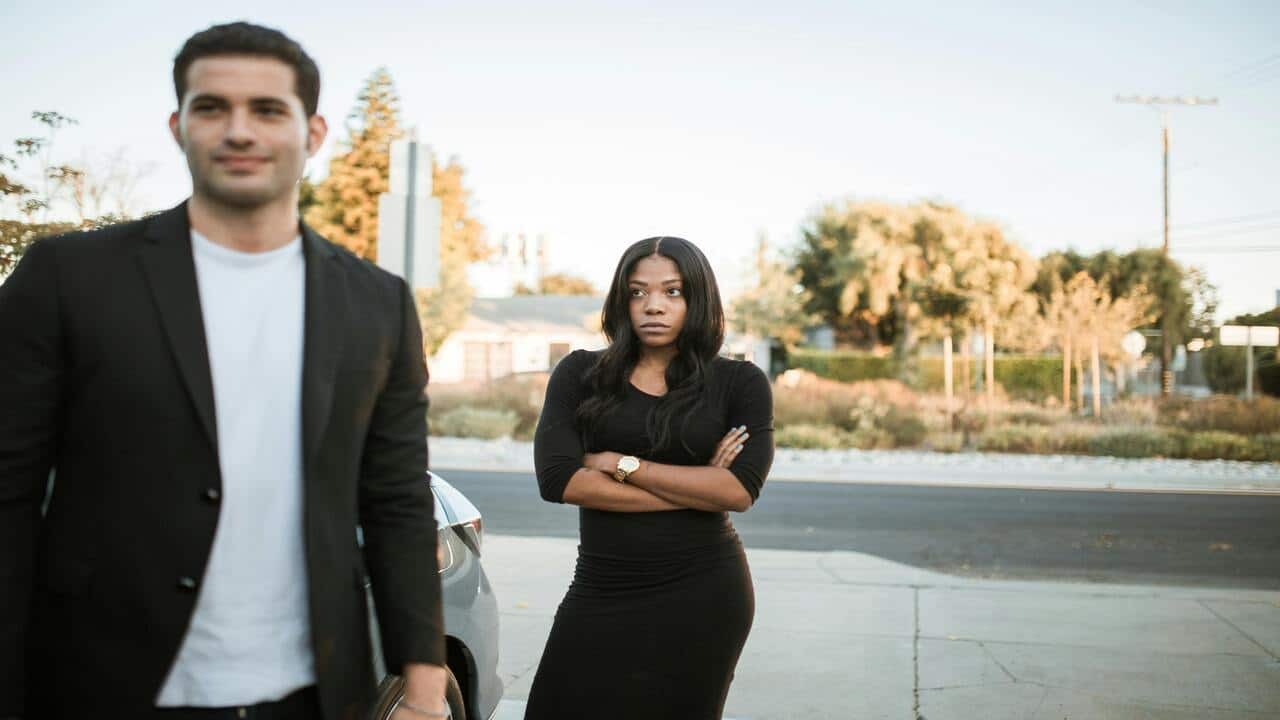 A woman looking upset at her boyfriend