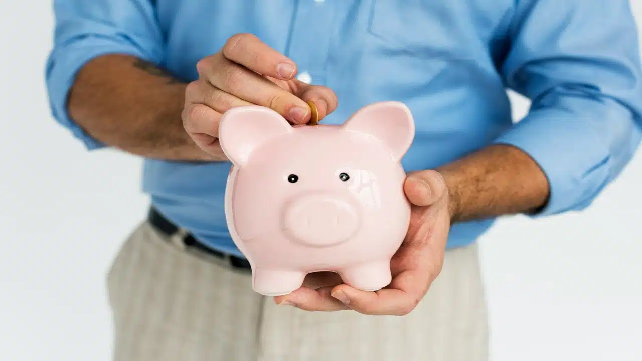 A man putting money in a piggy bank