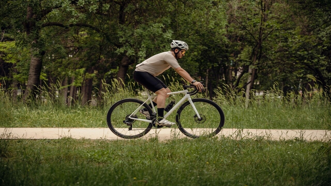 A man cycling down a dirt road
