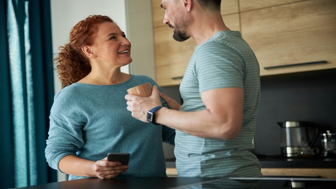 A couple looking at each other in the kitchen