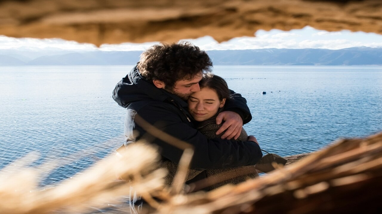 A couple hugging by the beach