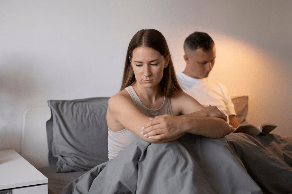 Upset couple in bed together