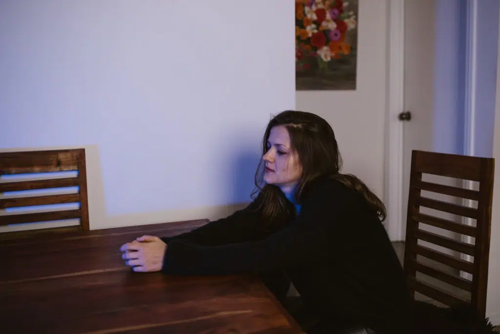 Disheartened Woman Sitting alone at a Table