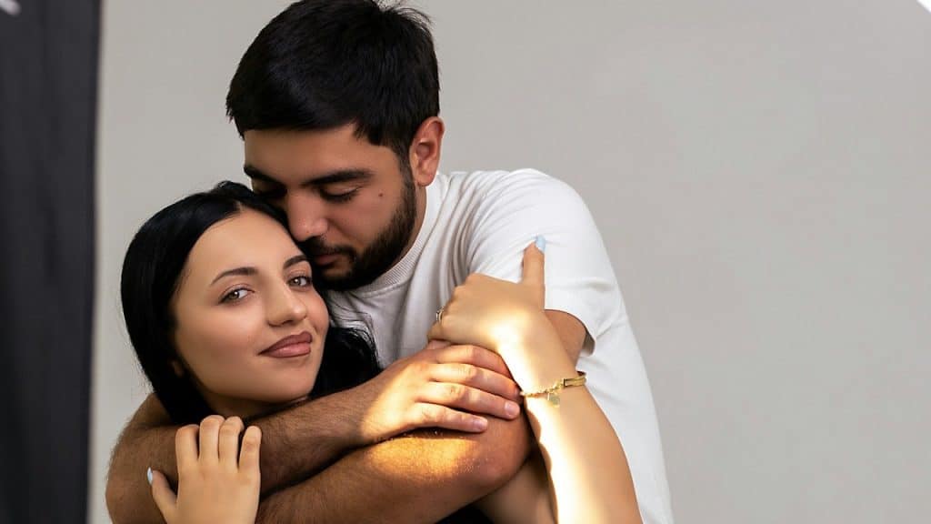 A man holding a woman tightly.
