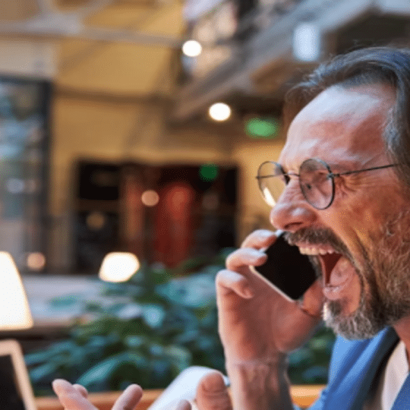 An angry man yelling at the phone