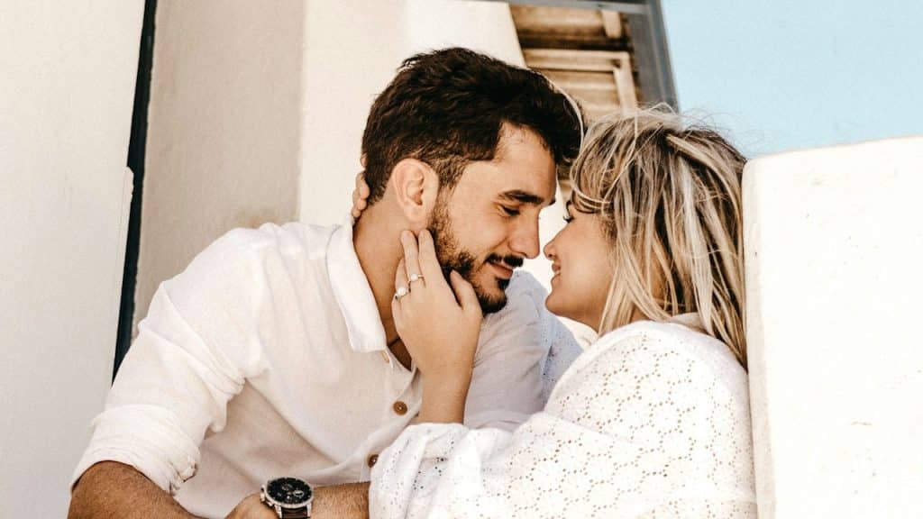 Smiling man and woman about to kiss each other.