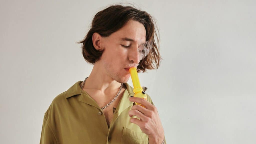 A man smoking a bong.