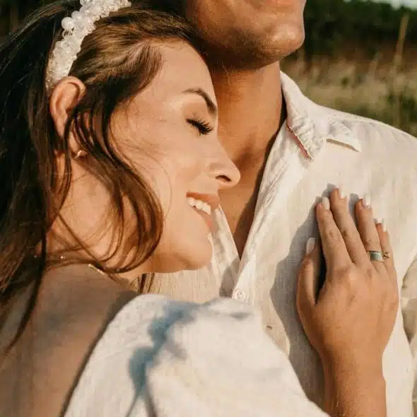 A woman resting her head on a man’s chest