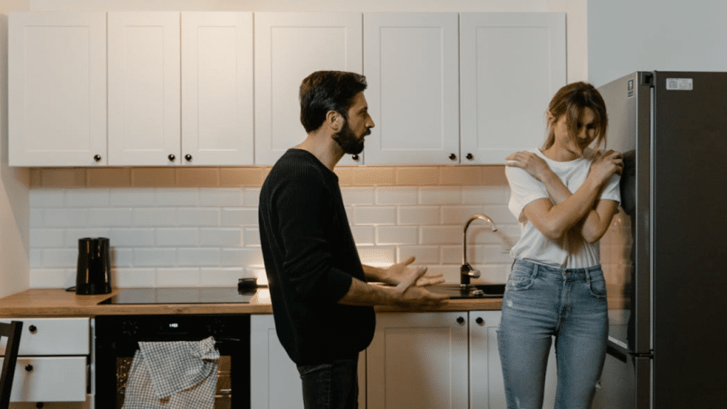 A man yelling at his wife in the kitchen
