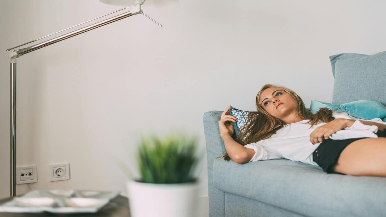 A woman looking sad at home