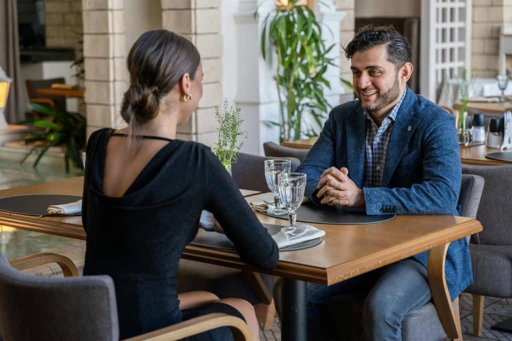 A man smiling at a woman
