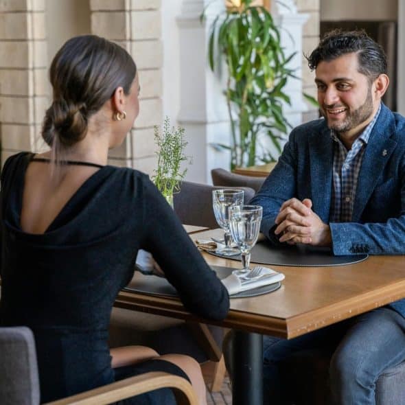 A man smiling at a woman