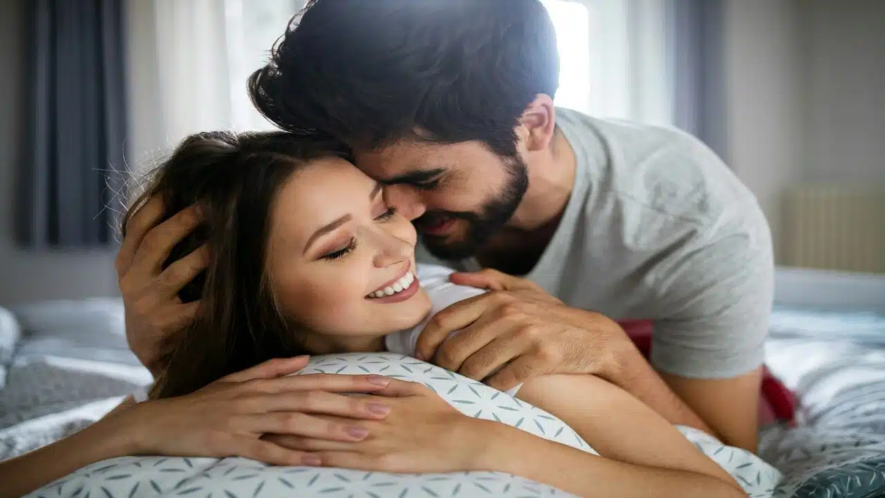 A couple cuddling in bed