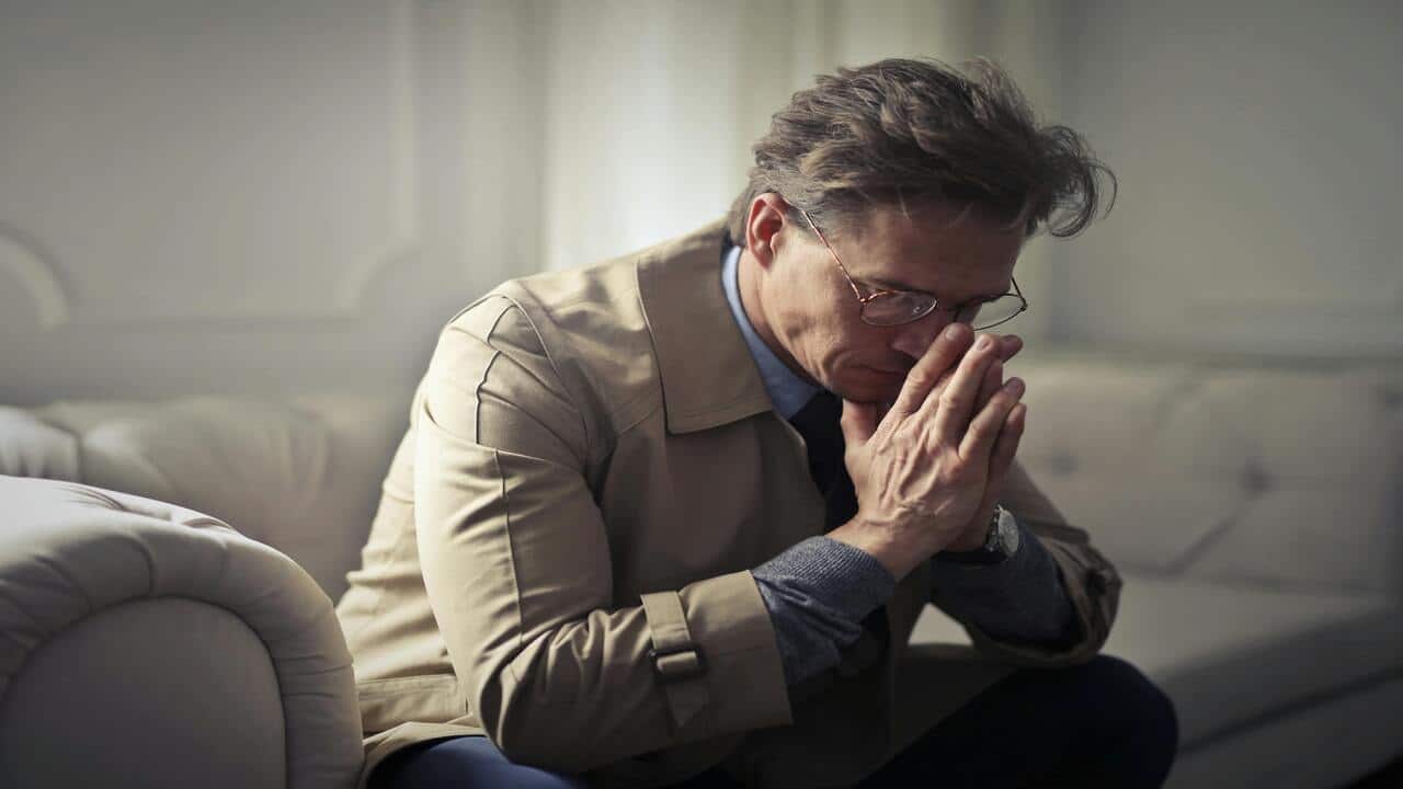 A man looking sad at home