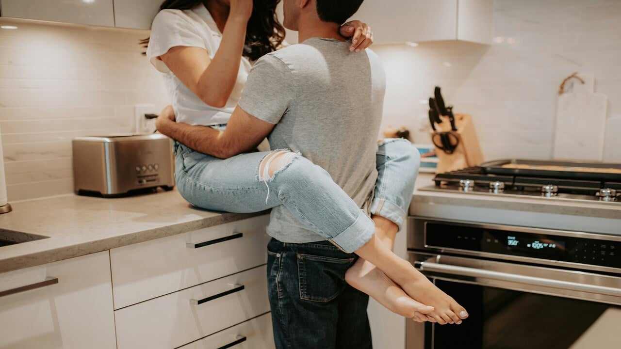 A couple hugging in the kitchen