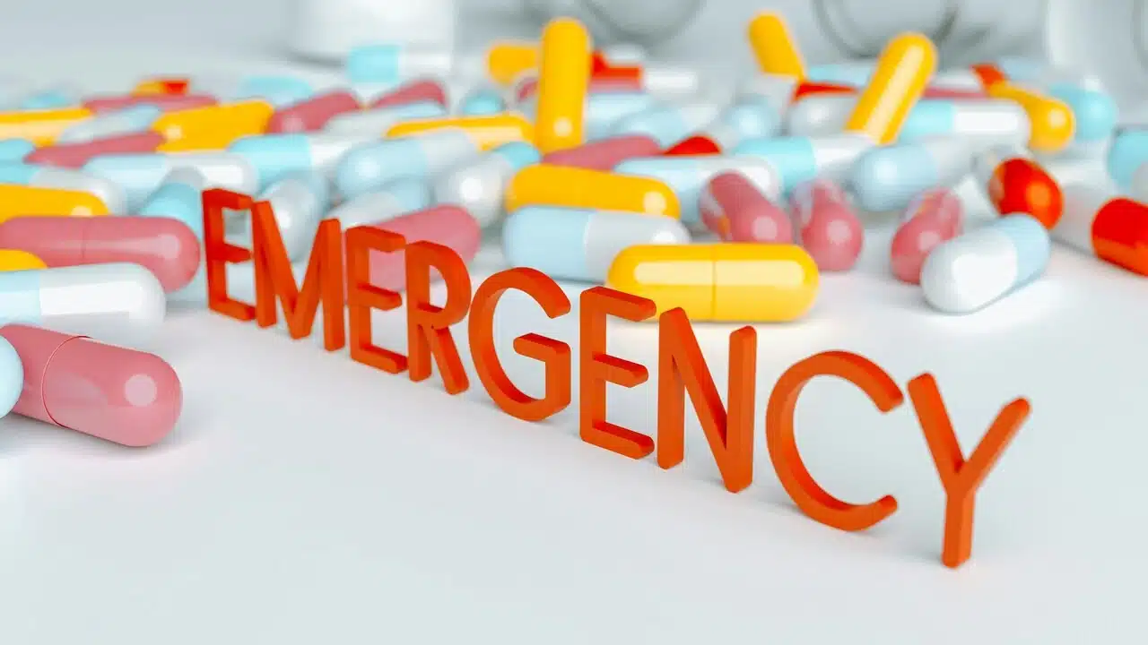 The word “emergency” surrounded by pills