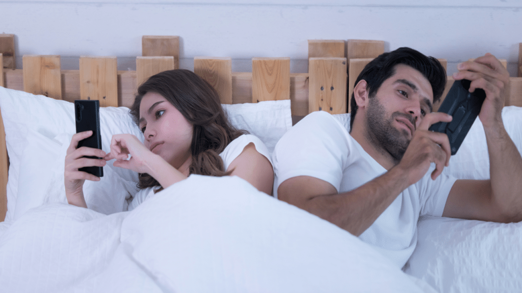 A couple using their phones at home