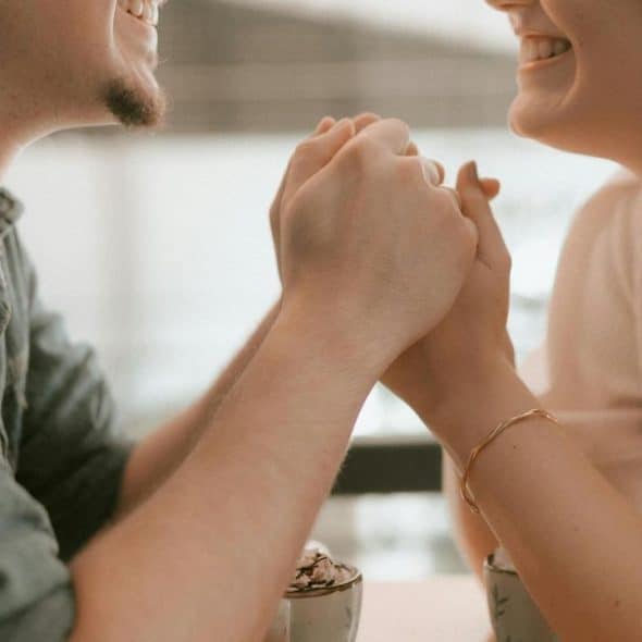 A couple smiles at each other