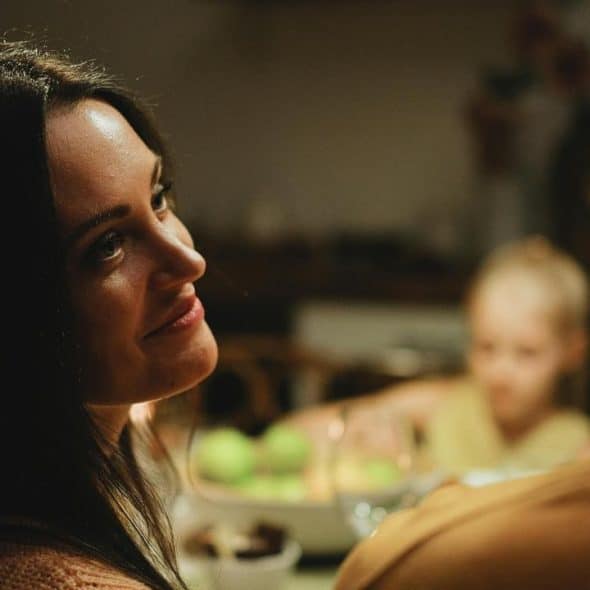 A woman gazing warmly at a man