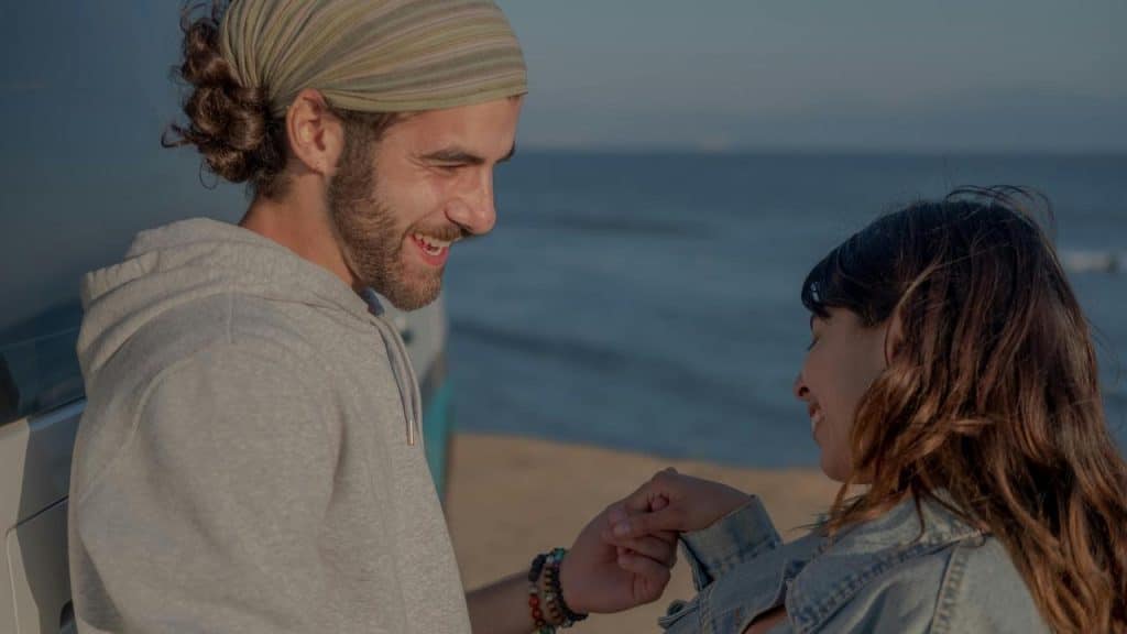 A smiling couple holding hands