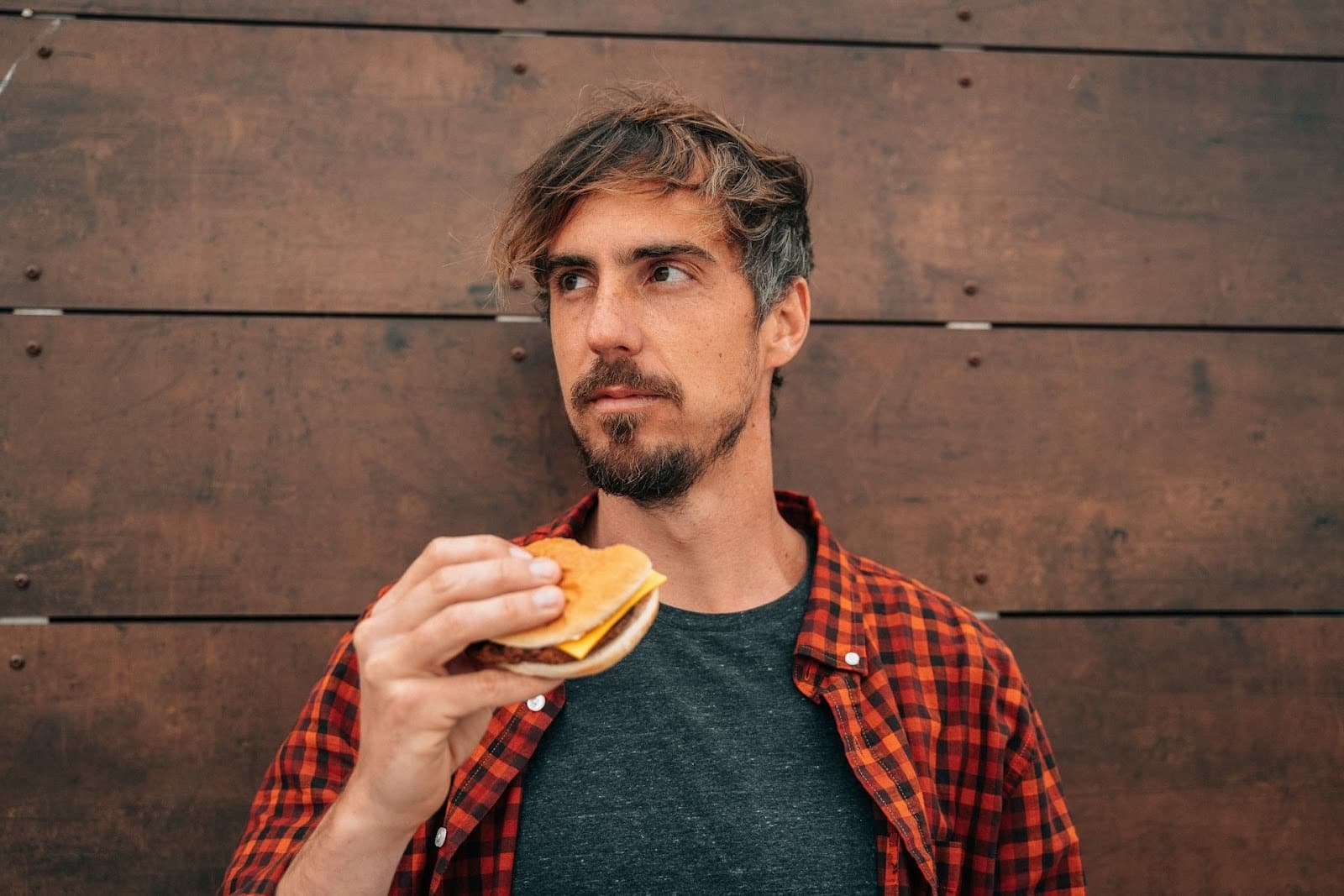 thoughtful man eating alone