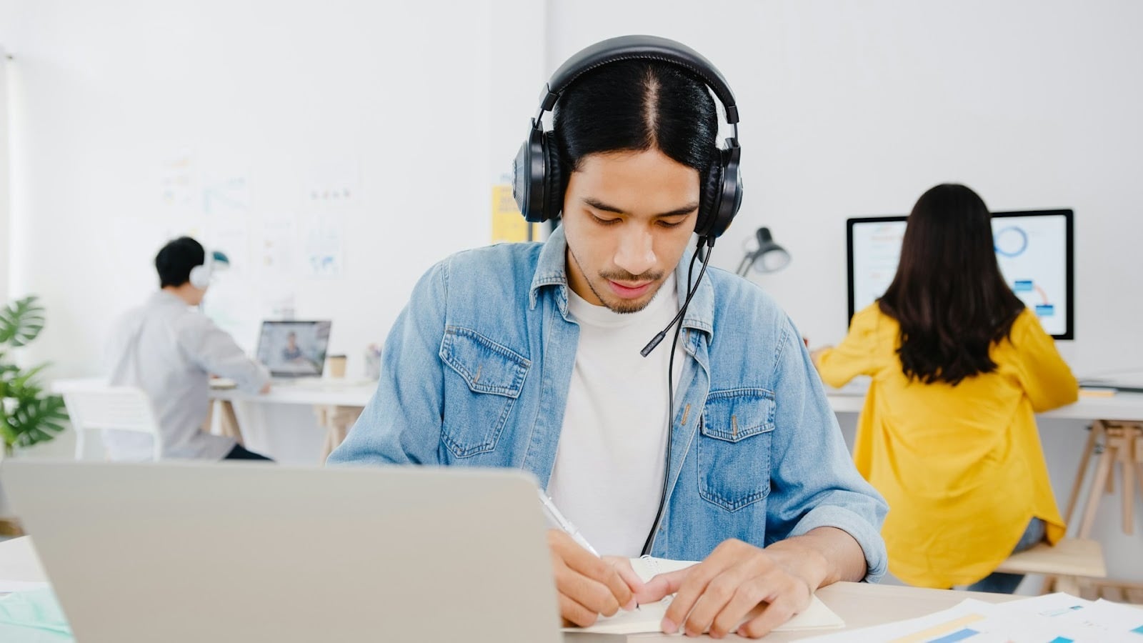 man writing notes