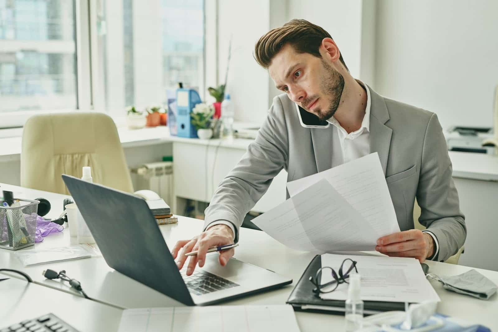 man multitasking office