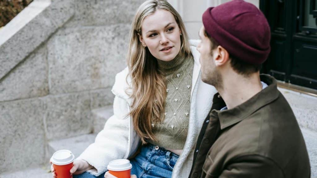 A woman and a man talking on outdoor steps