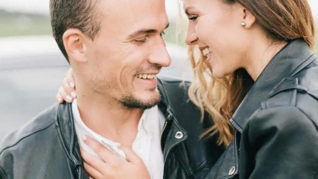 A smiling couple in leather jackets
