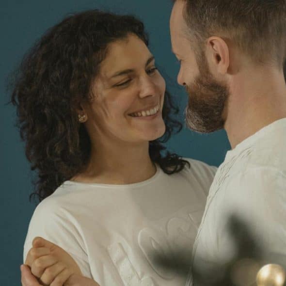 A smiling couple standing close together