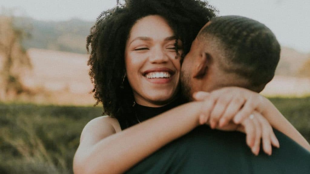 A happy woman hugging a man
