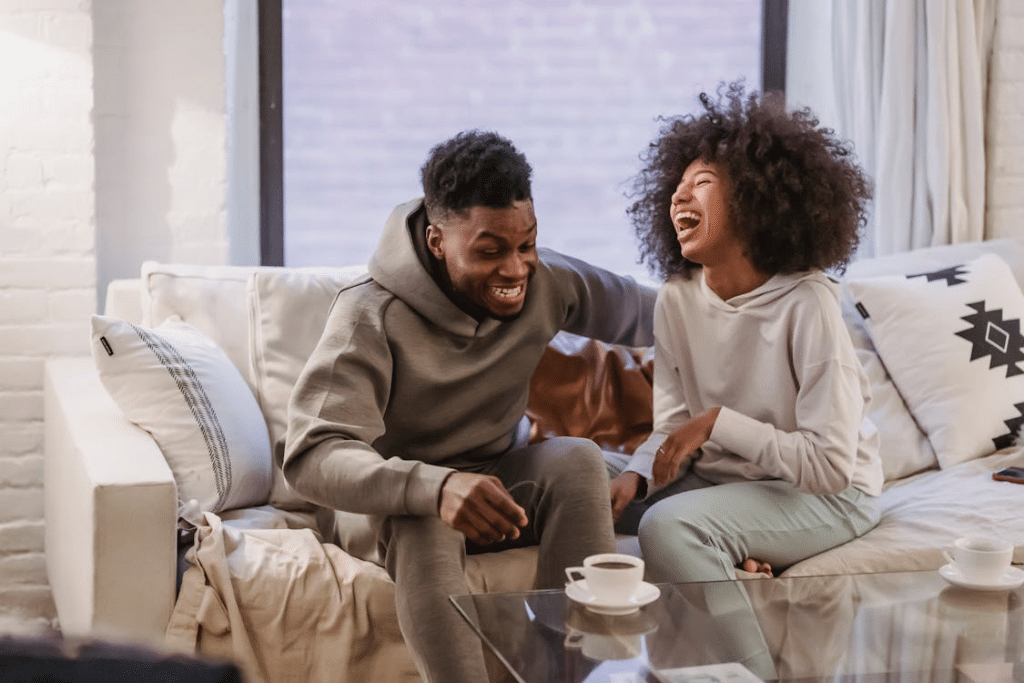 Couple having fun at couch at home