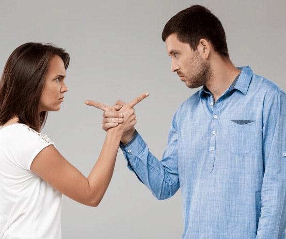Couple having an argument and pointing at each other