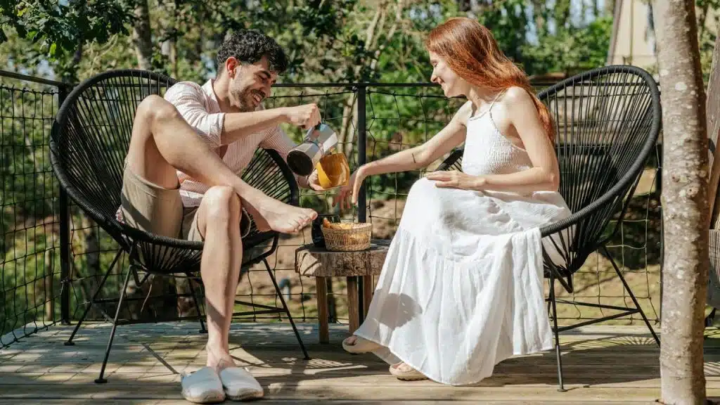 A couple enjoying tea together on an outdoor patio.