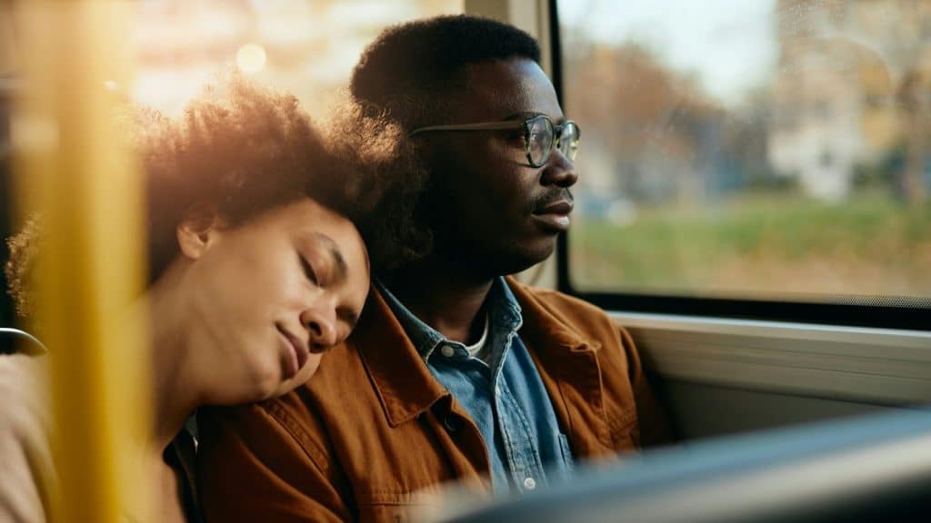 Woman resting her head on man’s shoulder