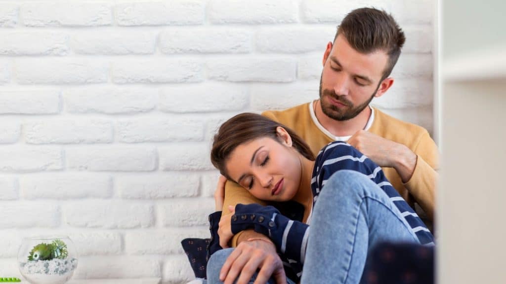 Woman resting on man’s shoulder