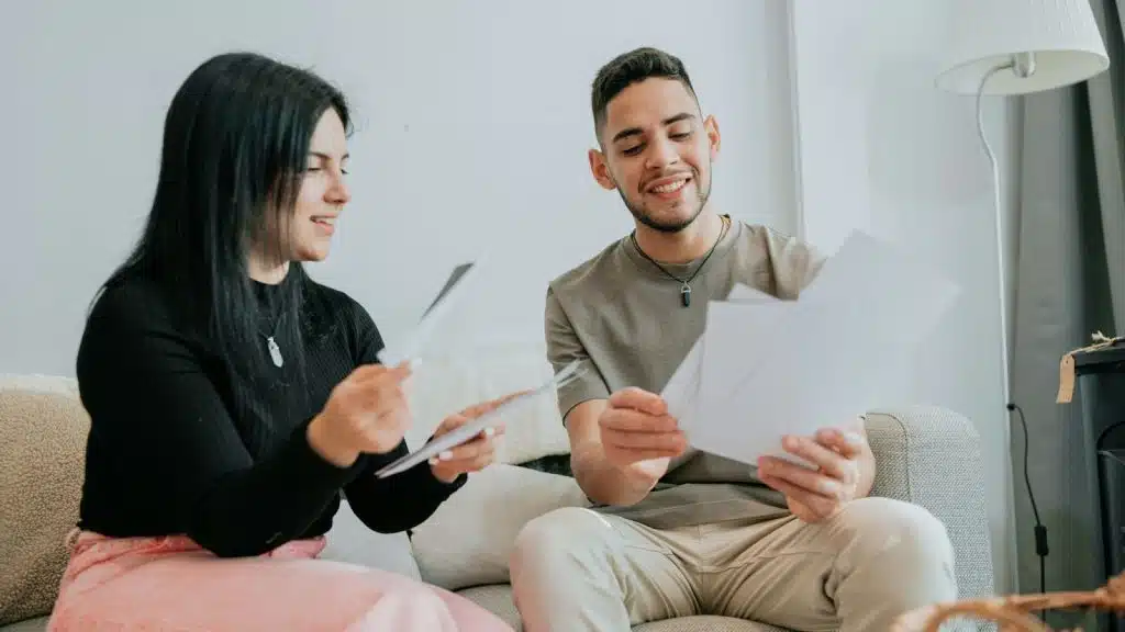 A man and woman checking their bills
