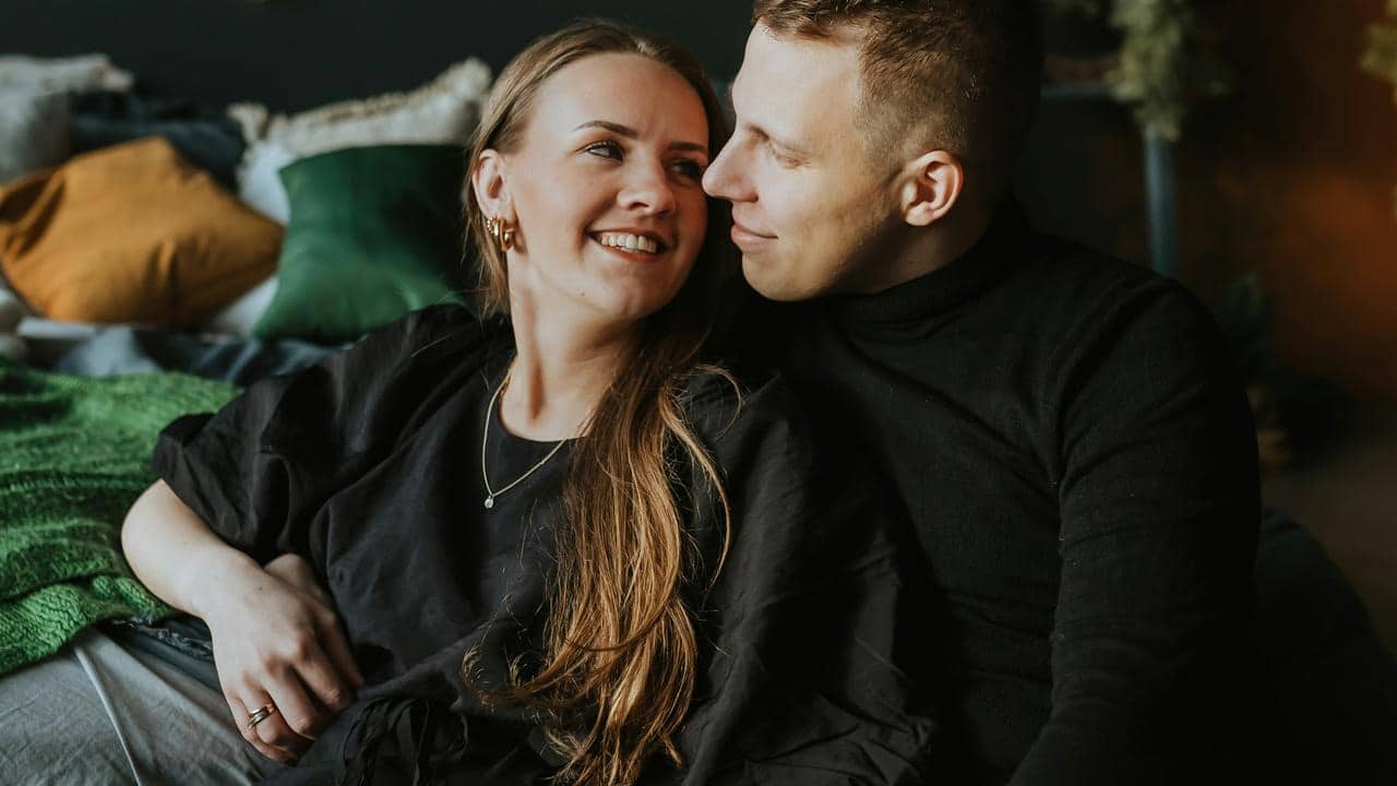 A couple relaxing together on a bed