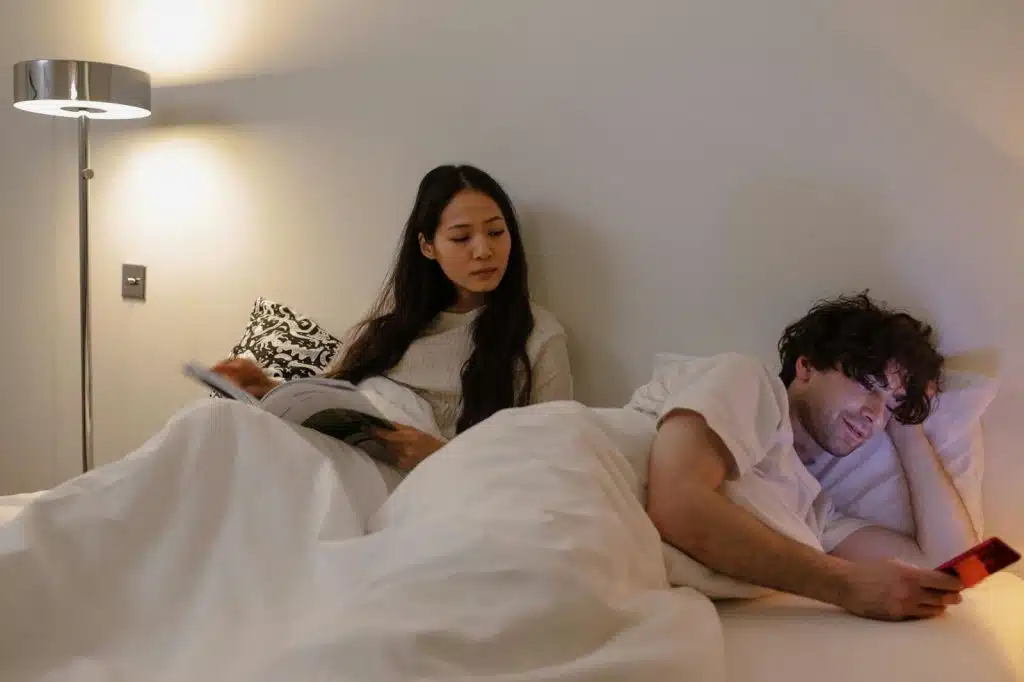 Woman observing a man that uses a phone