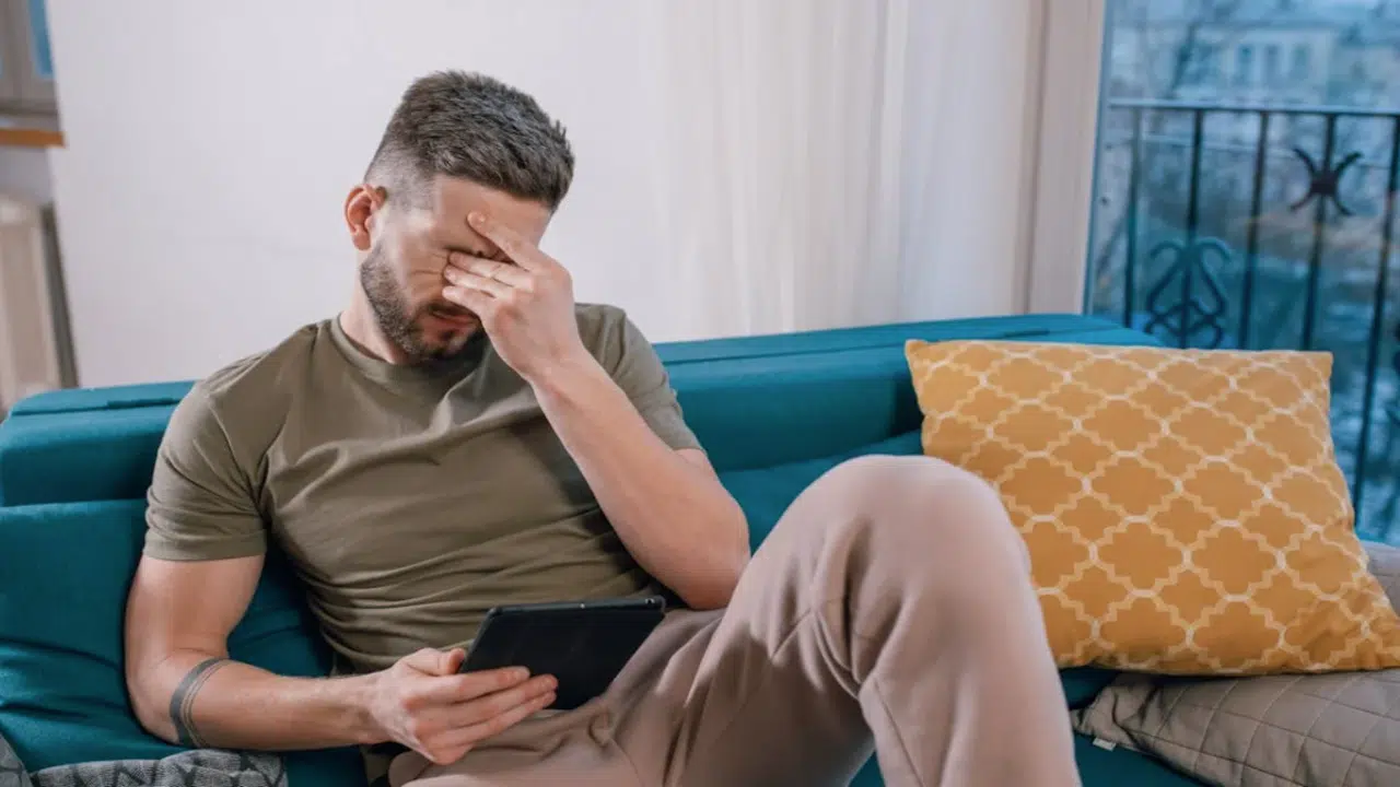 A man looking upset at home