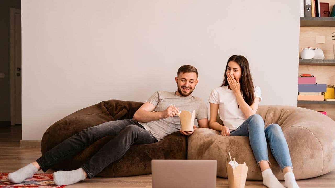 A couple sitting on a couch