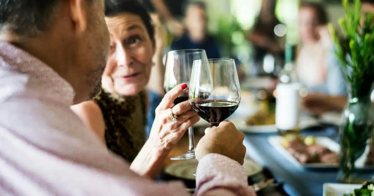 A group of people clinking glasses of red wine