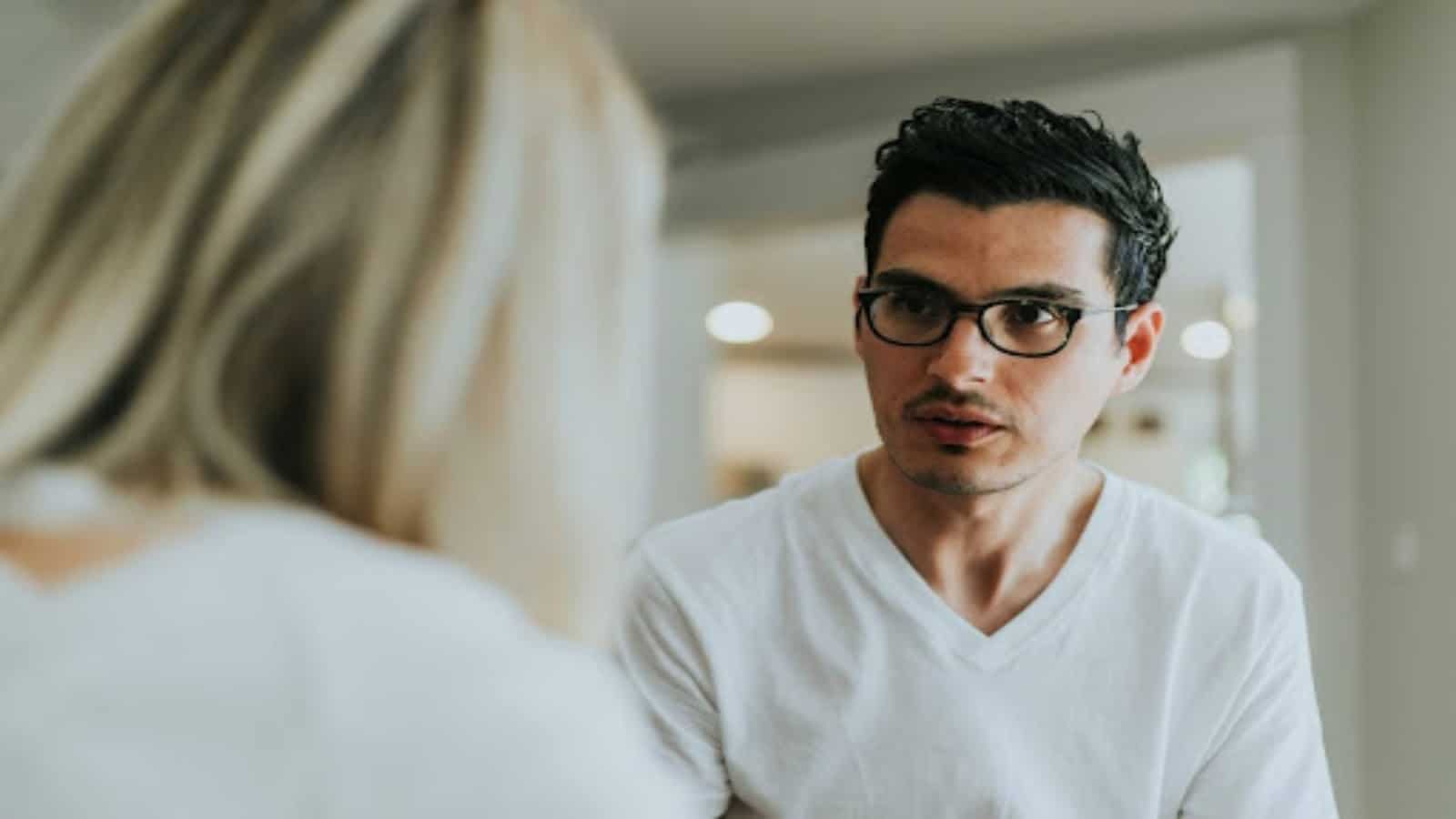 man listening seriously during conversation