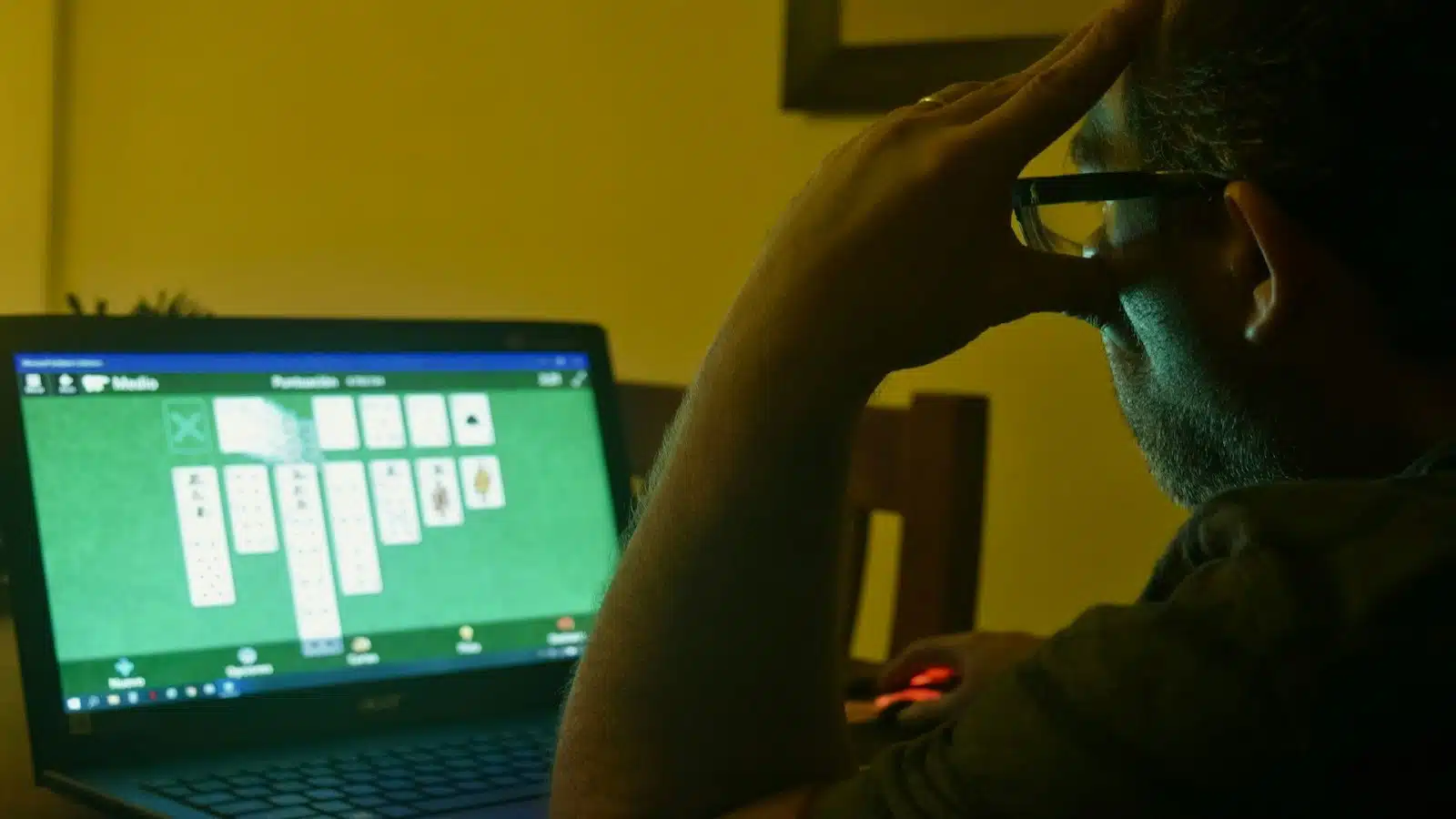 man closing laptop at home