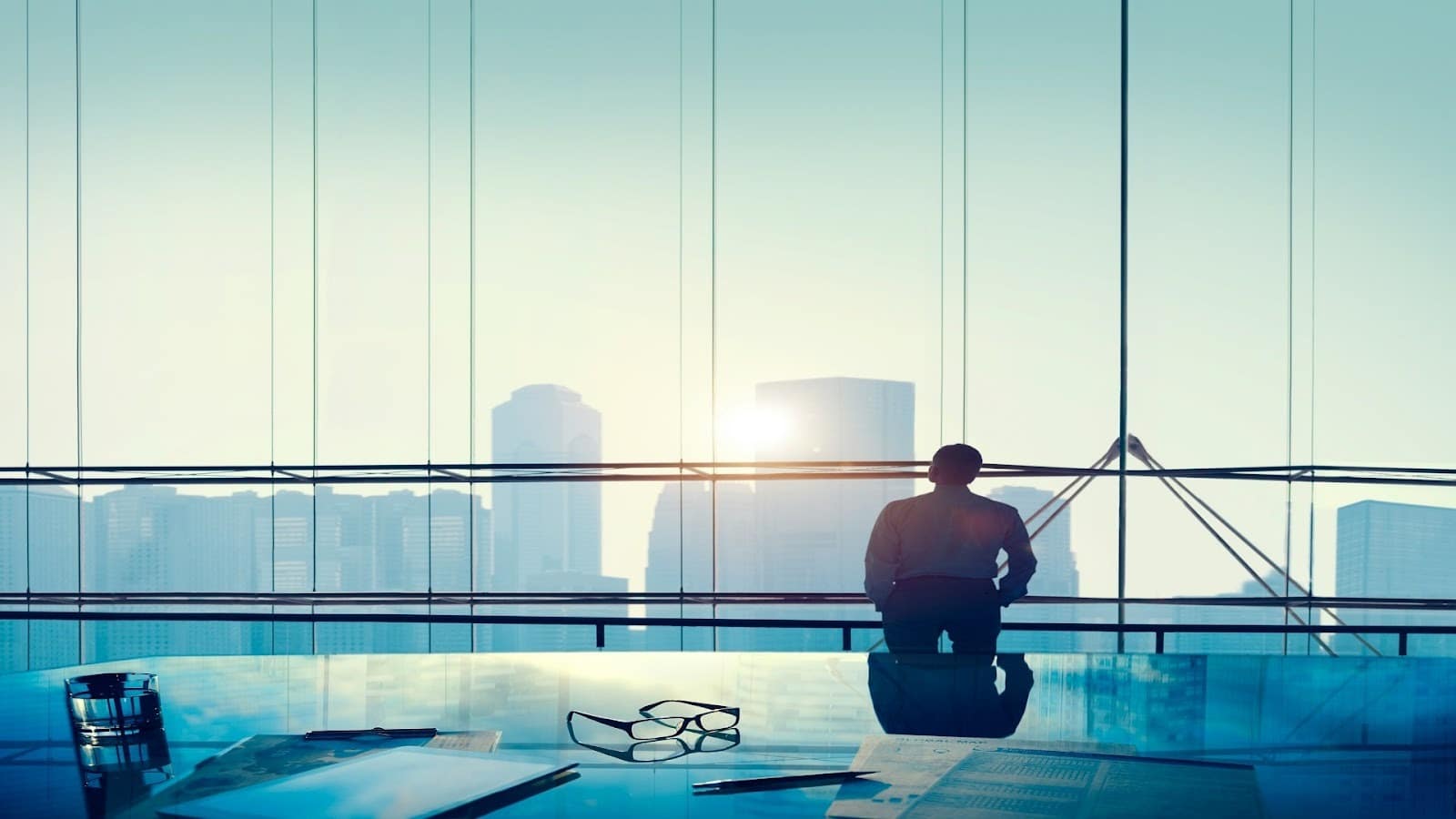 man looking thoughtful by window