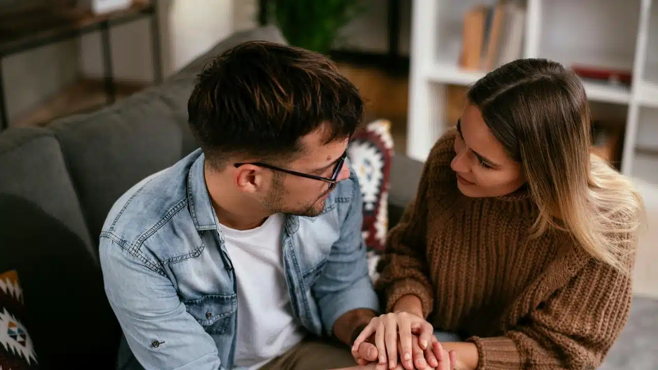 A couple sitting close together on a couch